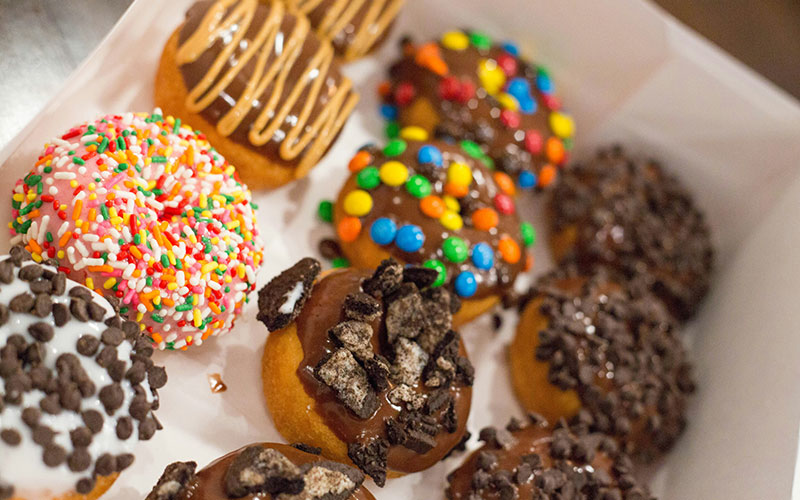 Mixed variety of donuts in white box