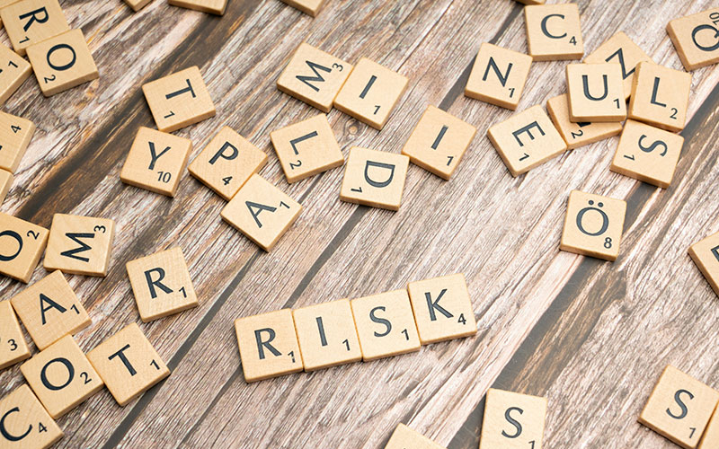 Scrabble tiles spelling out the word "risk"