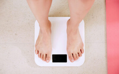 Person standing on white weight scale
