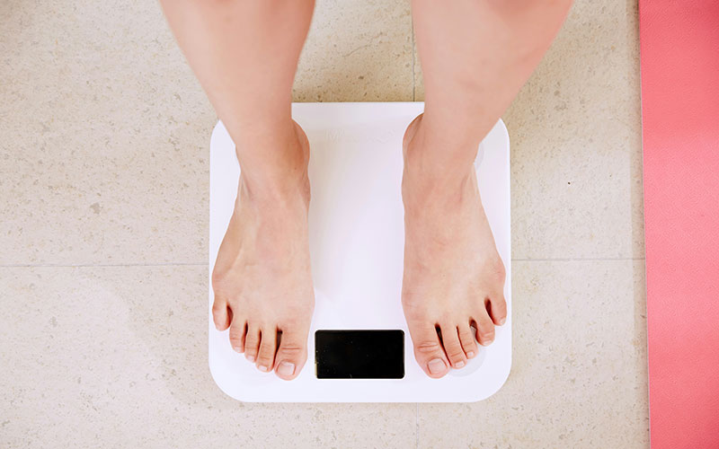 Person standing on white weight scale